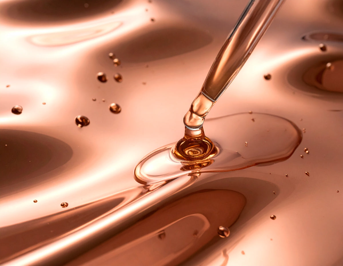 A dropper releasing PRIME serum onto skin before a tattoo appointment