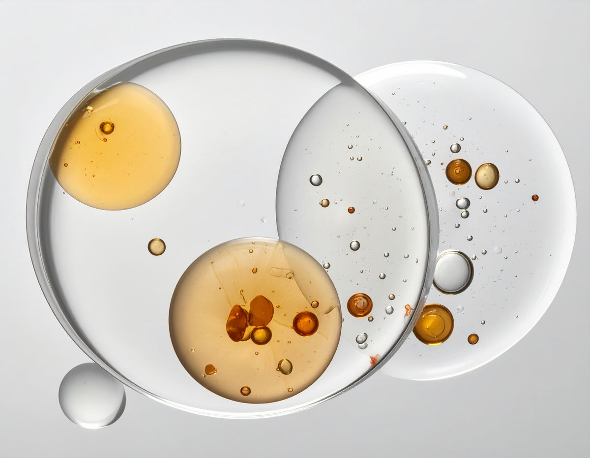Oil and serum droplets in glass dishes, the skin science behind SKINGRAPHICA tattoo care