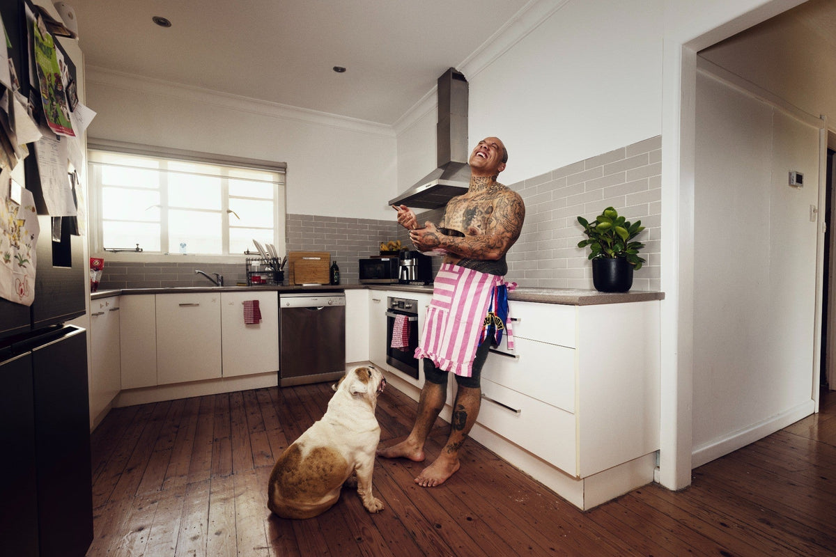 GRAPHICA Global Top 100 tattoo artist Chris Mata’afa at home with his dog, SKINGRAPHICA Featured Artist