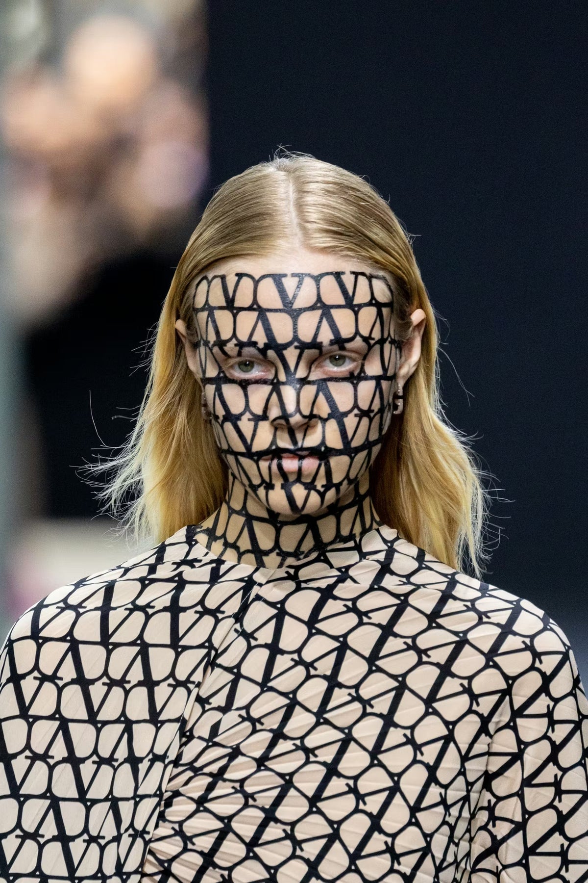 Model on a runway with a graphic face and body print, cover of the ICONICA January issue
