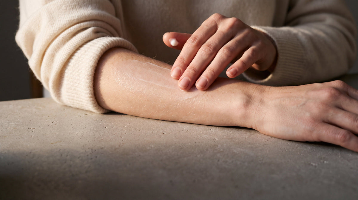 Fingertips smoothing a thin film of lotion over an inner forearm, when and how to apply lotion to a new tattoo