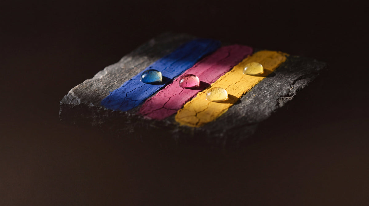 Beads of golden oil restoring faded cobalt, magenta and saffron pigment, the science of tattoo restoration