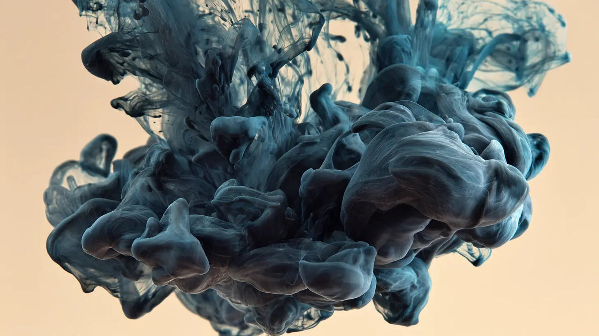 Black ink blooming through water, the science of why tattoos are permanent